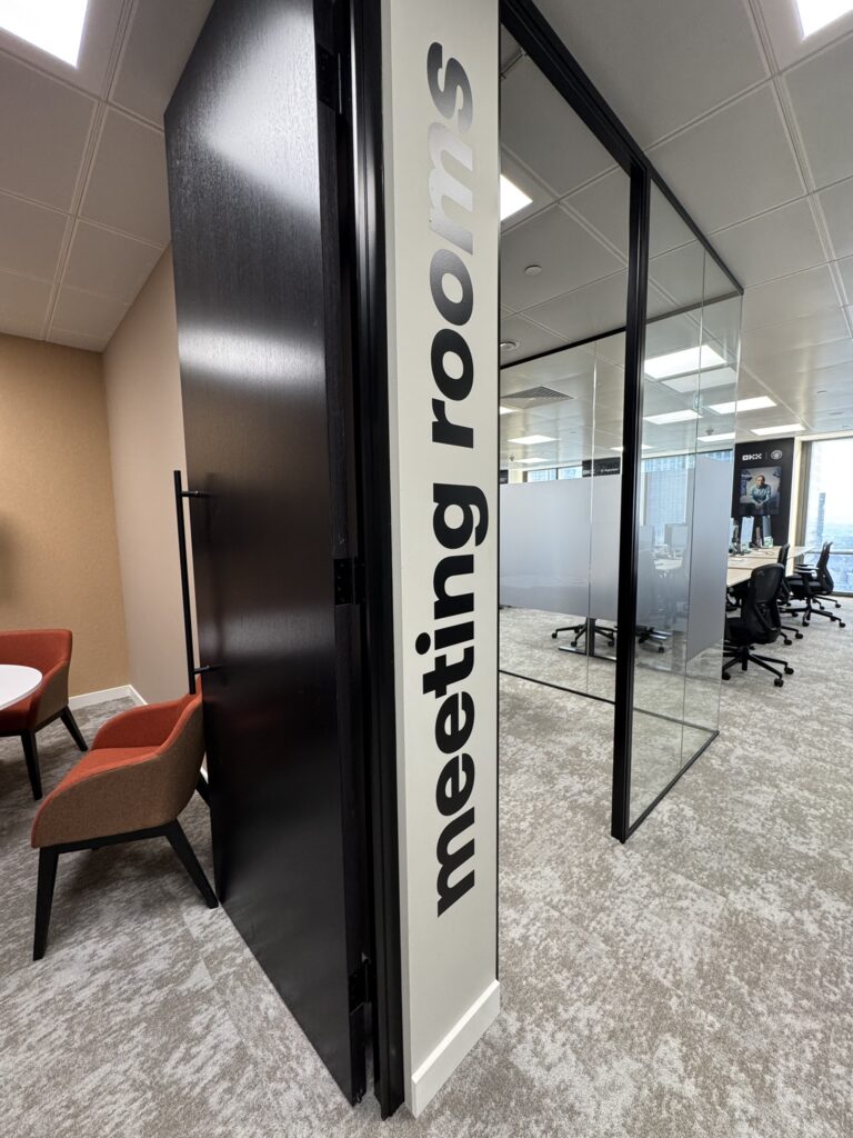 Meeting room lettering beside an office doorway